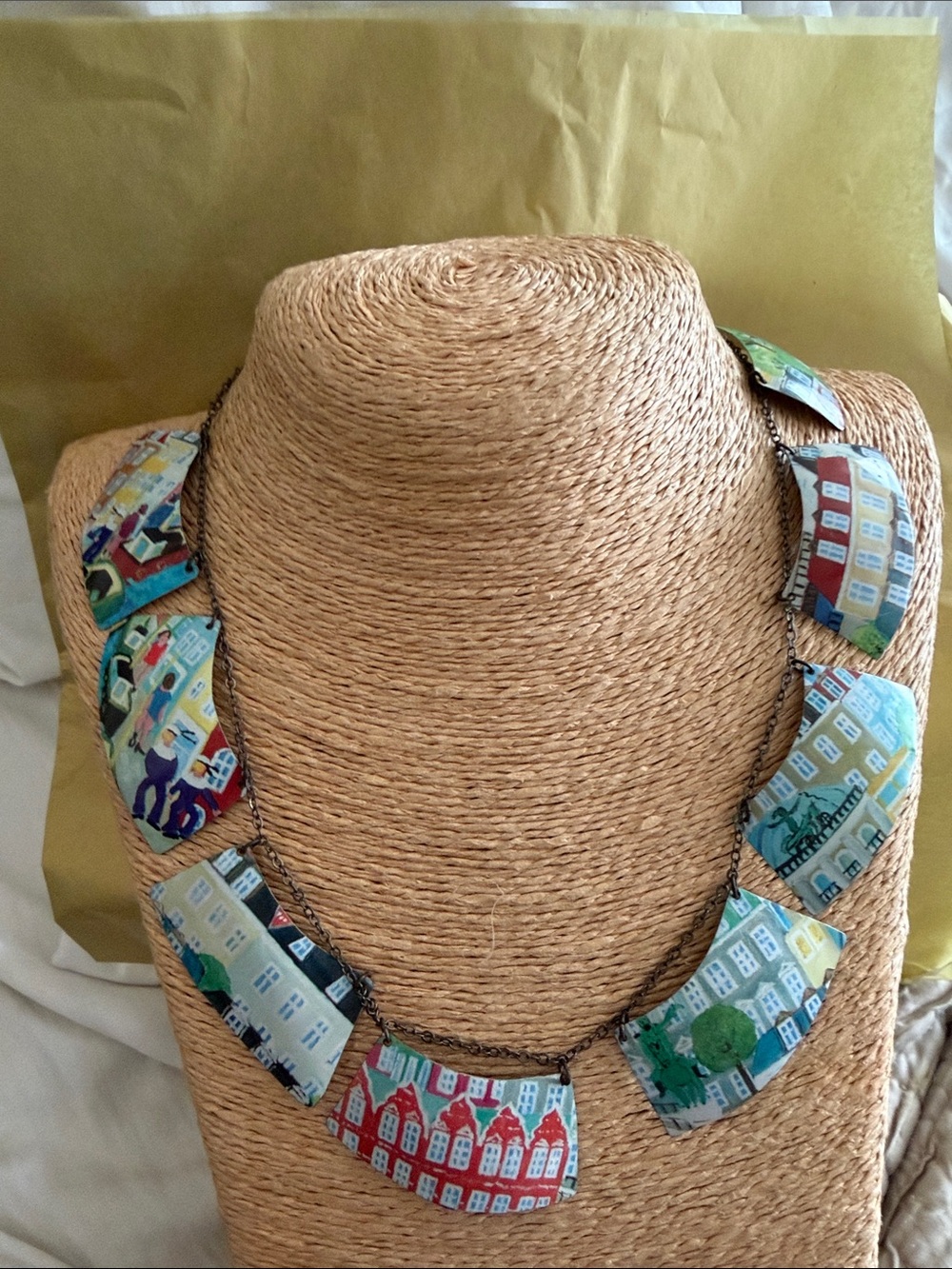 Interesting necklace on chain metal plates with scenery of different parts of